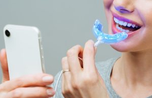 What are the key differences between professional and at-home teeth whitening?